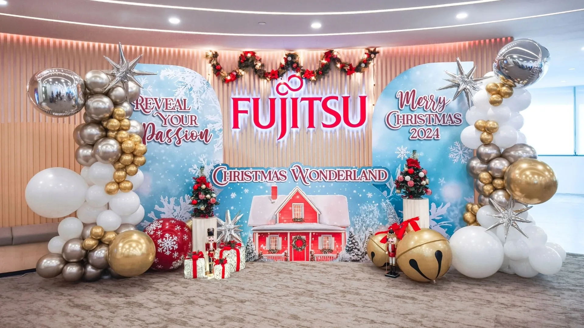 Fujitsu Christmas Wonderland event backdrop with christmas party decorations, christmas trees, nutcrackers and christmas balloon arches