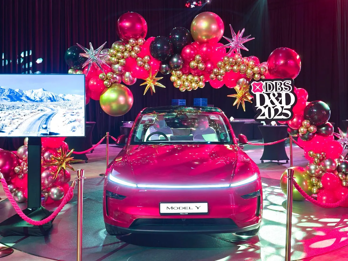 Car reveal staged under a balloon arch at a corporate dinner and dance, styled by The Happier Event Company