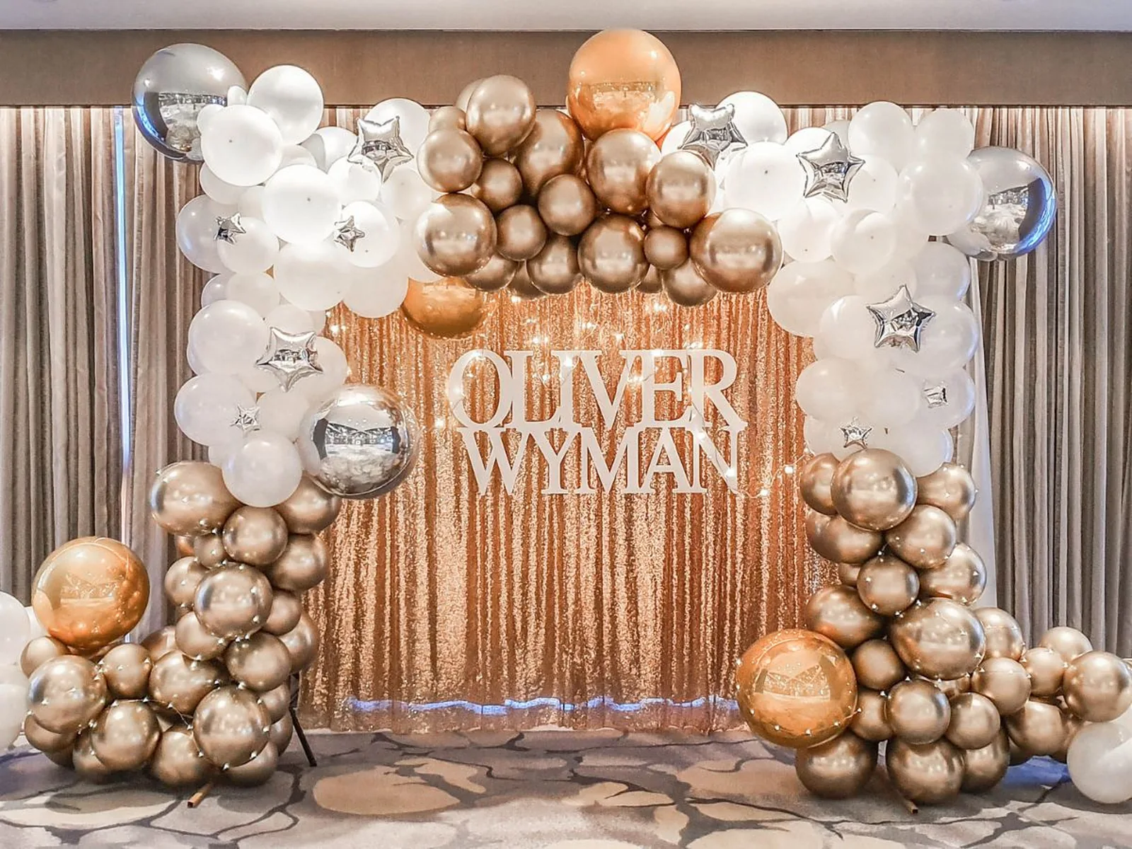 Corporate event stage backdrop and thematic décor styling by The Happier Event Company