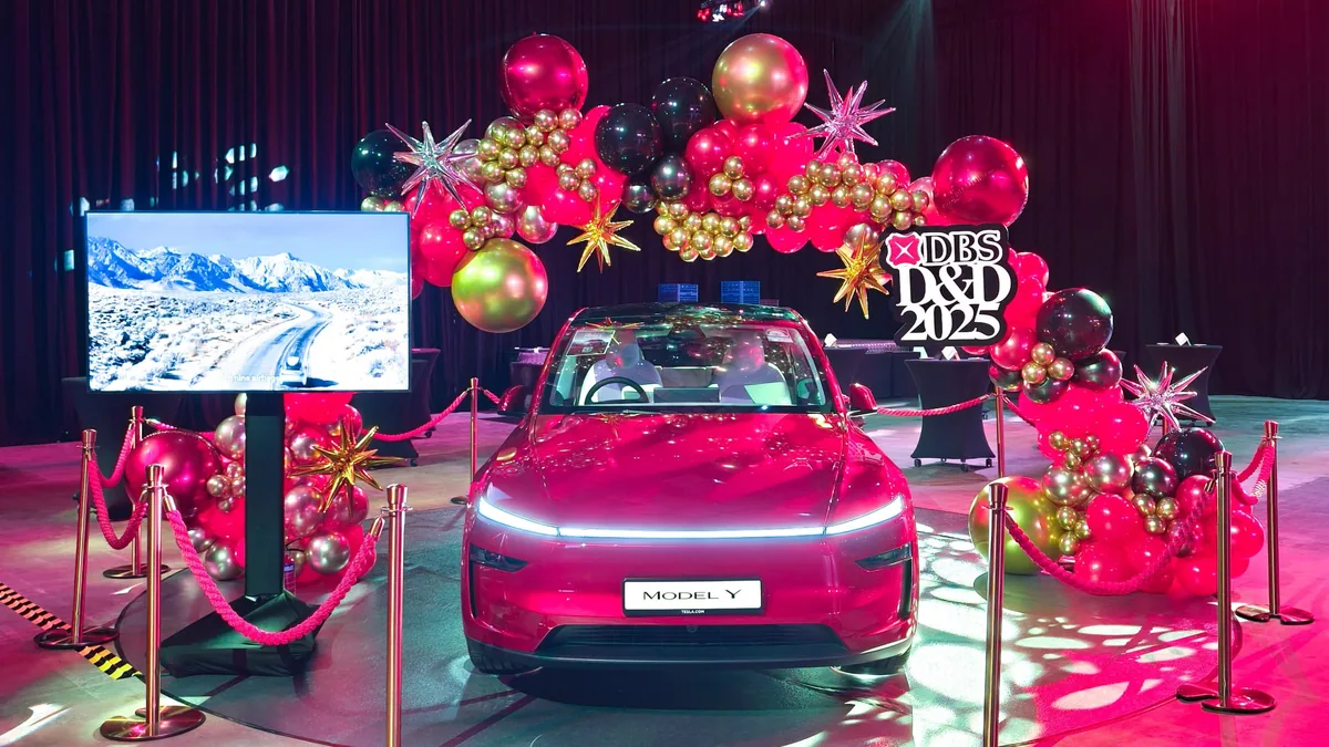 Car reveal staged under a star and balloon arch at a corporate dinner and dance, styled by The Happier Event Company