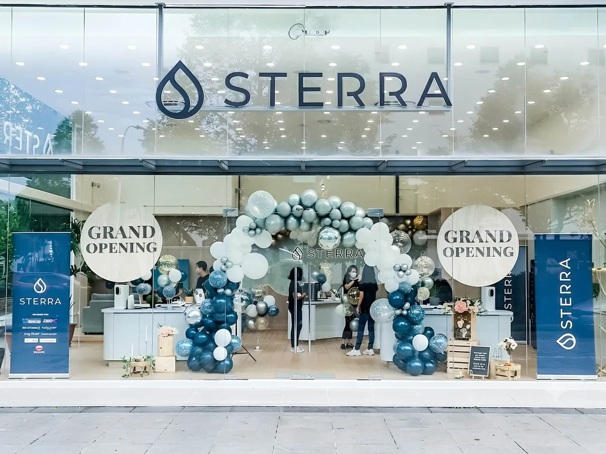 Retail store grand opening with a balloon entrance arch and window styling by The Happier Event Company