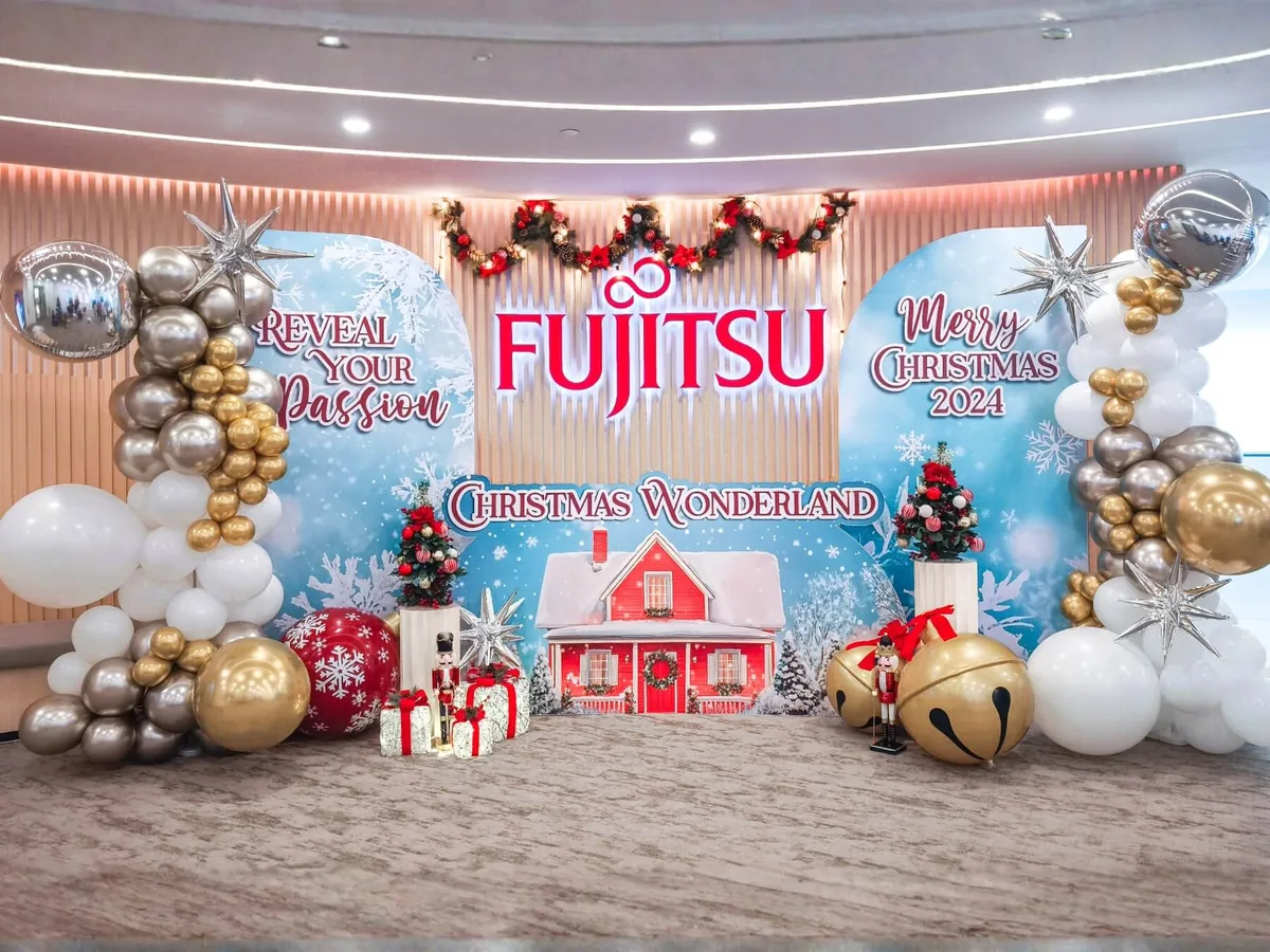 Office Christmas wonderland backdrop with themed props and balloon styling by The Happier Event Company