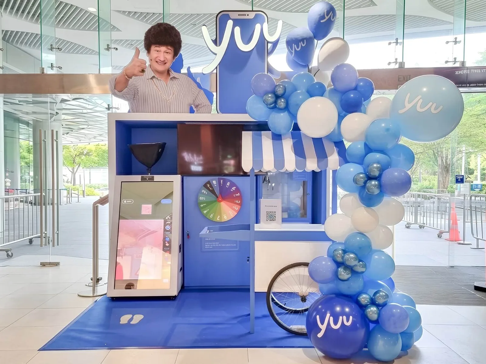 Branded mall activation cart with an interactive spin wheel and balloon garland, built by The Happier Event Company in Singapore