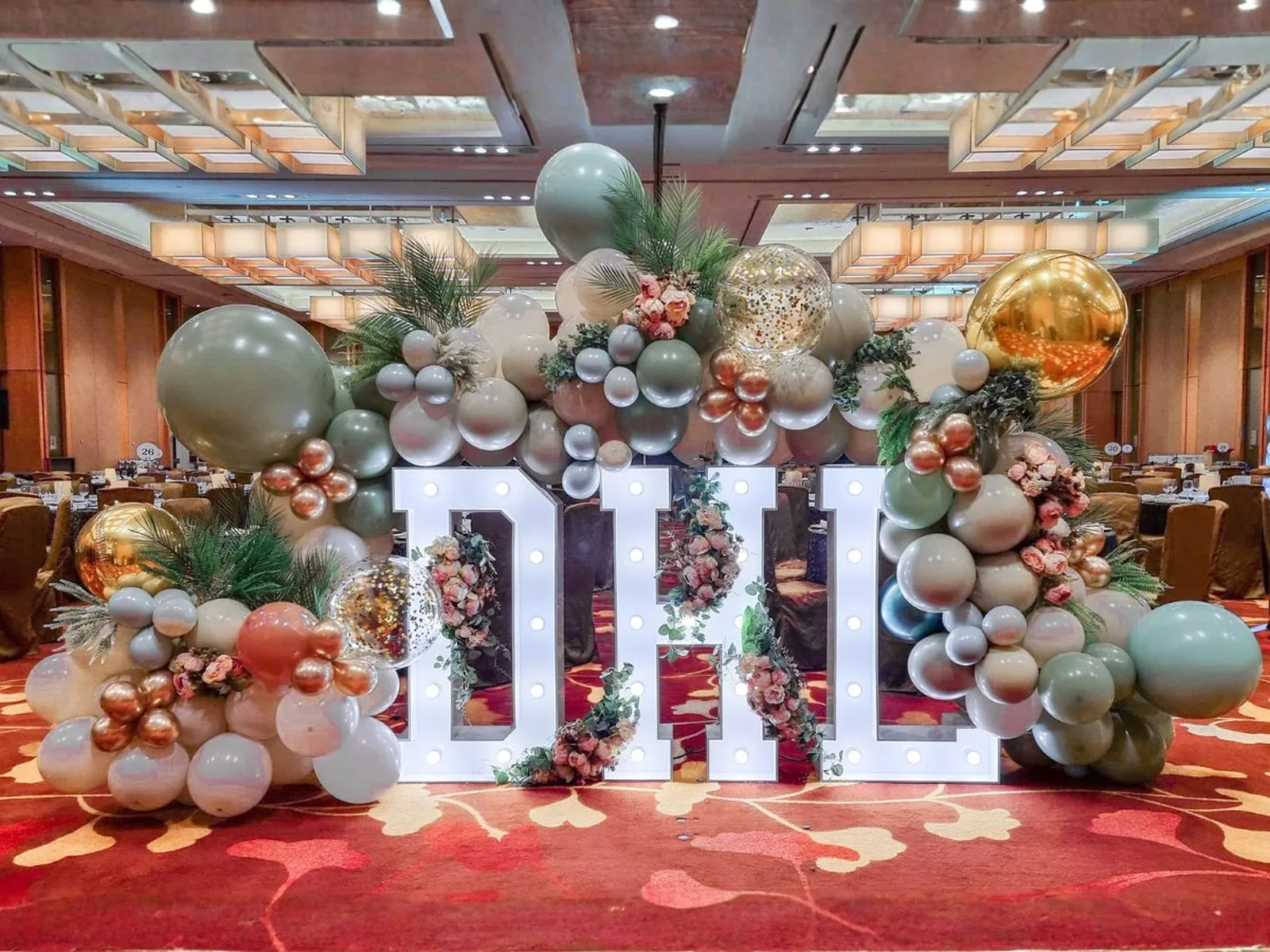 Giant branded letter installation and balloon garland built for a corporate event by The Happier Event Company